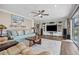 Cozy living room with a television, display shelves, neutral colors, and a comfortable seating area at 1745 Emerald Dr, Clearwater, FL 33756