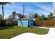 Backyard shed with blue painted siding, a single door, and concrete pad at 1745 Emerald Dr, Clearwater, FL 33756