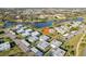 An aerial view showcasing the community, a pool, scenic lake and lush landscaping at 1901 Andover Way # 32, Sun City Center, FL 33573