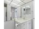 Bathroom view featuring a single sink vanity and mirrored wall at 1901 Andover Way # 32, Sun City Center, FL 33573