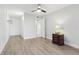 Neutral toned bedroom features wood flooring, ceiling fan and closet at 1901 Andover Way # 32, Sun City Center, FL 33573