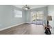 Bedroom with a ceiling fan, light blue walls, and wood laminate flooring at 1901 Andover Way # 32, Sun City Center, FL 33573