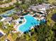 Aerial view of a resort-style community pool surrounded by palm trees and lush landscaping at 1901 Andover Way # 32, Sun City Center, FL 33573