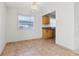 A bright dining area with tile flooring that offers a glimpse into the kitchen at 1901 Andover Way # 32, Sun City Center, FL 33573