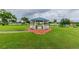 Charming blue-roofed gazebo with benches offers a tranquil outdoor space for relaxation at 1901 Andover Way # 32, Sun City Center, FL 33573