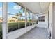 Screened-in lanai showing the view of a lawn with mature palm trees at 1901 Andover Way # 32, Sun City Center, FL 33573