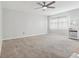 A bright and airy living room with a large window and neutral colored carpet at 1901 Andover Way # 32, Sun City Center, FL 33573