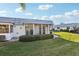 A charming screened-in patio provides a seamless transition to the outdoors and lush landscaping at 1901 Andover Way # 32, Sun City Center, FL 33573