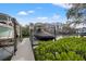 This private boat lift provides easy access to the water with lush greenery and views at 192 Haven Beach Dr, Indian Rocks Beach, FL 33785