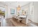 Bright dining room featuring seating for eight, chandelier and views to the outside at 192 Haven Beach Dr, Indian Rocks Beach, FL 33785