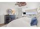 Main bedroom with large windows, dark wood dresser, and ensuite bathroom, creating a relaxing retreat at 192 Haven Beach Dr, Indian Rocks Beach, FL 33785