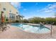 Beautiful community pool with ample seating, lush landscaping, and clear blue skies at 192 Haven Beach Dr, Indian Rocks Beach, FL 33785