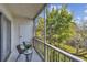 Screened balcony with outdoor chairs and a view of the green landscape at 205 S Mcmullen Booth Rd # 202, Clearwater, FL 33759