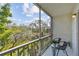 Screened balcony with a seating area and lush green views at 205 S Mcmullen Booth Rd # 202, Clearwater, FL 33759