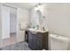 Bathroom vanity with dark wood, oval mirror, and neutral tile flooring at 205 S Mcmullen Booth Rd # 202, Clearwater, FL 33759