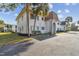 Charming two-story condo building showcasing a stucco exterior, arched entryways, and neatly landscaped surroundings at 205 S Mcmullen Booth Rd # 202, Clearwater, FL 33759