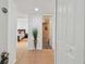 Bright foyer featuring tile flooring, plant decoration, and a hallway leading to the bedroom at 205 S Mcmullen Booth Rd # 202, Clearwater, FL 33759