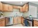 Well-lit kitchen with stainless steel appliances, wood cabinets, and tiled backsplash at 205 S Mcmullen Booth Rd # 202, Clearwater, FL 33759