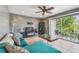 Stylish living room featuring tile floors, a ceiling fan and a balcony with a view of greenery at 205 S Mcmullen Booth Rd # 202, Clearwater, FL 33759