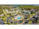 Aerial shot of the community pool and clubhouse, surrounded by lush landscaping and ample parking at 205 S Mcmullen Booth Rd # 202, Clearwater, FL 33759