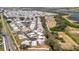 Drone's view of the community with a road winding through the homes, plus solar panels at 206 S Port Royal Ln, Apollo Beach, FL 33572