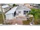 Aerial view of home with an adjacent carport, small patio, palm tree and white fence at 206 S Port Royal Ln, Apollo Beach, FL 33572