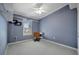 Simple bedroom with blue walls, and a desk that offers a dedicated workspace at 206 S Port Royal Ln, Apollo Beach, FL 33572