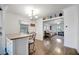 Open-concept dining area with wood floors that seamlessly connects to a cozy living room, perfect for modern living and entertaining at 206 S Port Royal Ln, Apollo Beach, FL 33572