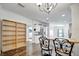 Open dining area with wood floors, modern lighting and breakfast bar that connects to kitchen at 206 S Port Royal Ln, Apollo Beach, FL 33572