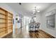 Open dining area featuring wood floors, modern chandelier, white walls and breakfast bar with decorative bar stools at 206 S Port Royal Ln, Apollo Beach, FL 33572