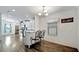 Bright dining area with breakfast bar, wood-look floors, modern lighting and large window at 206 S Port Royal Ln, Apollo Beach, FL 33572