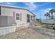 Landscaped exterior features brick and paving stones, including a gray HVAC unit at 206 S Port Royal Ln, Apollo Beach, FL 33572