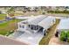 Single-story home featuring a covered carport and a well manicured lawn at 206 S Port Royal Ln, Apollo Beach, FL 33572