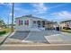 Single-story home with covered carport and landscaped yard under a bright, sunny sky at 206 S Port Royal Ln, Apollo Beach, FL 33572