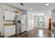 Kitchen featuring stainless steel refrigerator, white cabinets and granite counters at 206 S Port Royal Ln, Apollo Beach, FL 33572