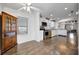 Bright kitchen with stainless steel appliances, wood-look floors, white cabinetry, and a ceiling fan at 206 S Port Royal Ln, Apollo Beach, FL 33572