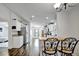 Open kitchen featuring stainless steel appliances, granite counters, breakfast bar, wood floors and white cabinetry at 206 S Port Royal Ln, Apollo Beach, FL 33572