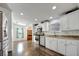 White kitchen featuring stainless steel appliances, granite counters, hardwood floors and eat in breakfast area at 206 S Port Royal Ln, Apollo Beach, FL 33572