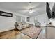 Inviting living room boasting lots of windows, wood-look floors, ceiling fan, and comfortable seating for relaxation at 206 S Port Royal Ln, Apollo Beach, FL 33572