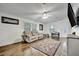 Bright living room with lots of windows, wood-look floors, ceiling fan, and lots of natural light at 206 S Port Royal Ln, Apollo Beach, FL 33572