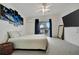 Bright main bedroom with a ceiling fan, plush carpet, and sliding glass doors leading to an outdoor balcony for relaxation at 206 S Port Royal Ln, Apollo Beach, FL 33572