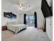 Bright main bedroom with a ceiling fan, plush carpet, and sliding glass doors leading to an outdoor balcony for relaxation at 206 S Port Royal Ln, Apollo Beach, FL 33572