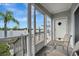 Enclosed patio features white railings, grey siding, and views of a fenced-in yard with palm trees at 206 S Port Royal Ln, Apollo Beach, FL 33572