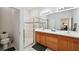 Well-lit bathroom featuring a dual sink vanity, a glass shower enclosure, and marble floors at 2471 Kensington Greens Dr, Sun City Center, FL 33573