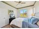 Bedroom with a bed dressed in white and blue bedding, a black dresser, and a wallpaper border near the ceiling at 2471 Kensington Greens Dr, Sun City Center, FL 33573