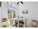 Cozy dining area with large window, complemented by a charming table setup and natural light at 2471 Kensington Greens Dr, Sun City Center, FL 33573