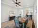 Charming dining room with a farmhouse table and seating, accented by a modern ceiling fan and coastal decor at 2471 Kensington Greens Dr, Sun City Center, FL 33573