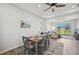 The dining room features a wood table with blue chairs and a light fixture above at 2471 Kensington Greens Dr, Sun City Center, FL 33573