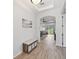 A light and bright foyer features an arched doorway and light hardwood floors leading to the living area at 2471 Kensington Greens Dr, Sun City Center, FL 33573