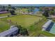 Scenic lawn bowling court with benches and a lake in the background, perfect for recreation and leisure at 2471 Kensington Greens Dr, Sun City Center, FL 33573